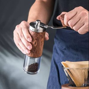 Manual coffee grinder showing burr alignment and hand-powered grinding