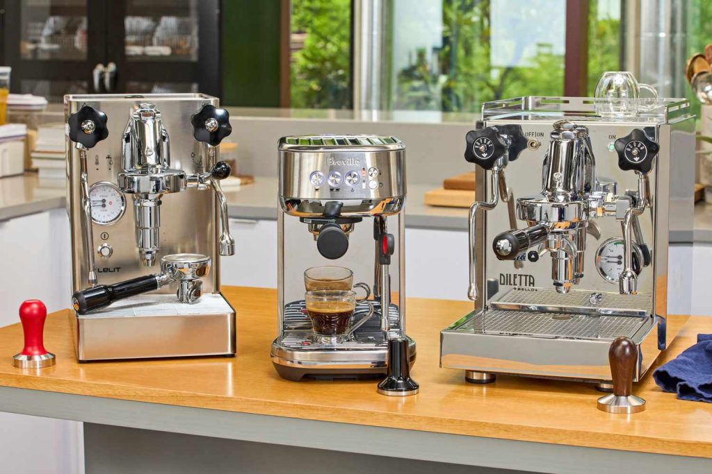 multiple high-end espresso machines displayed side by side on a counter
